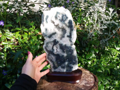 Huge Agate Crystal Geode Slice specimen on wood display stand.